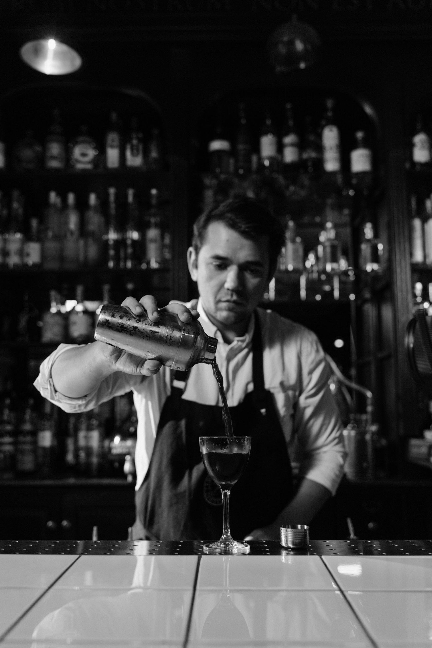 Bartender pouring a cocktail